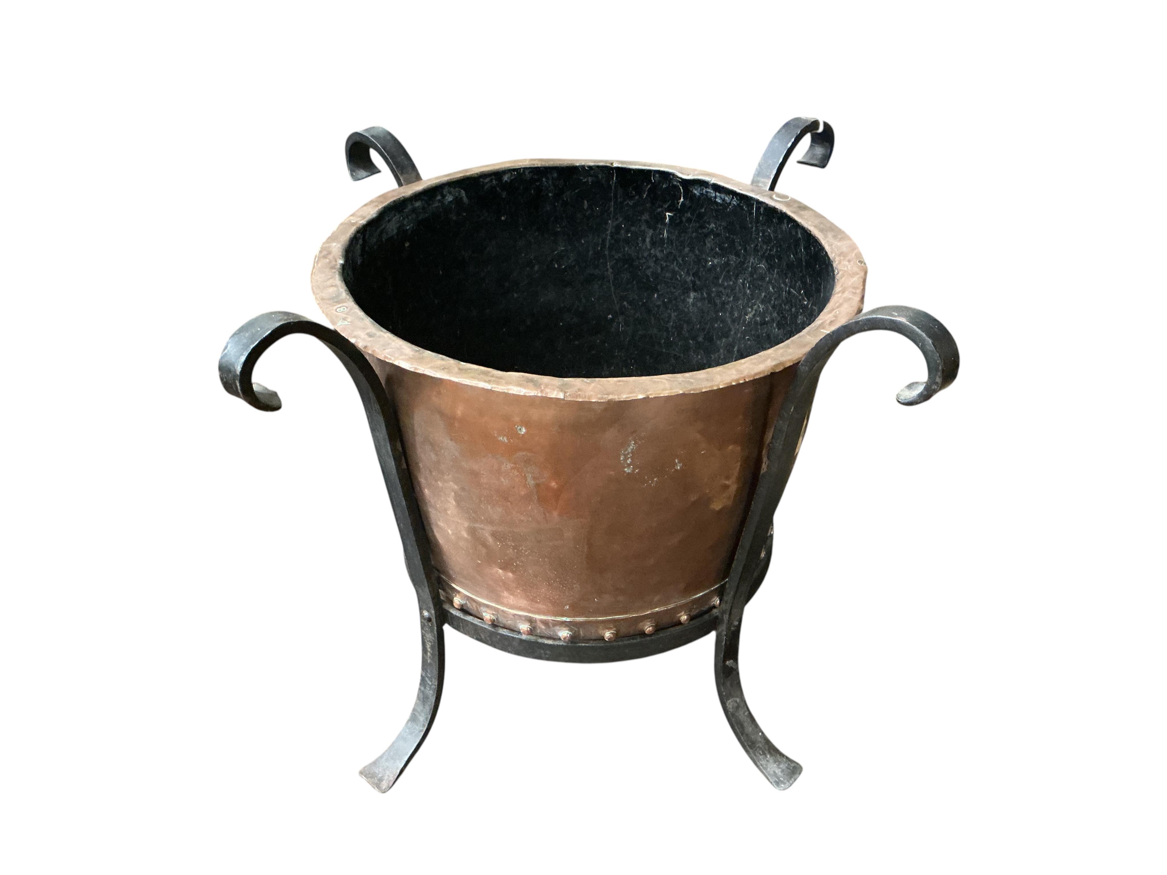 A small Victorian circular copper copper, raised in a wrought iron frame, width 64cm, height 50cm